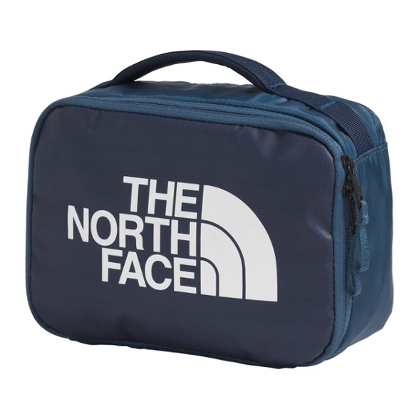 The North Face Base Camp Voyager toiletry kit hanging in a bathroom with organized toiletries inside