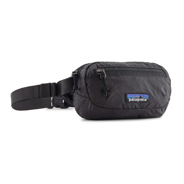 Patagonia Terravia Compact Hip Pack worn as a crossbody bag during a hike, displaying its weather-resistant material.