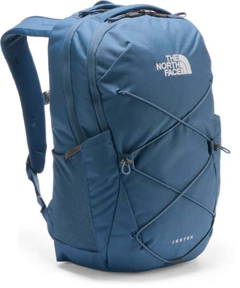 North Face Jester Daypack worn by hiker on trail, showcasing ergonomic straps and water bottle pockets
