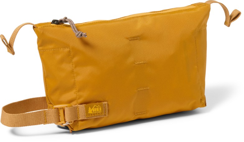Large hanging toiletry bag showcased on a shower rod, ideal for travel organization.