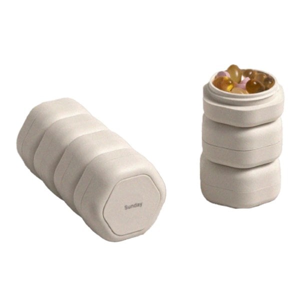 Overhead shot of pill case with labeled compartments from Monday to Sunday