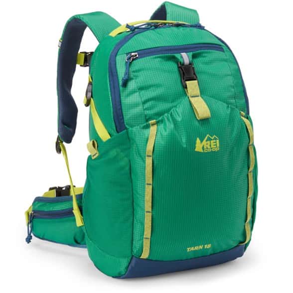 Child packing snacks in the REI Co-op Tarn 18 kids' hiking pack outdoors