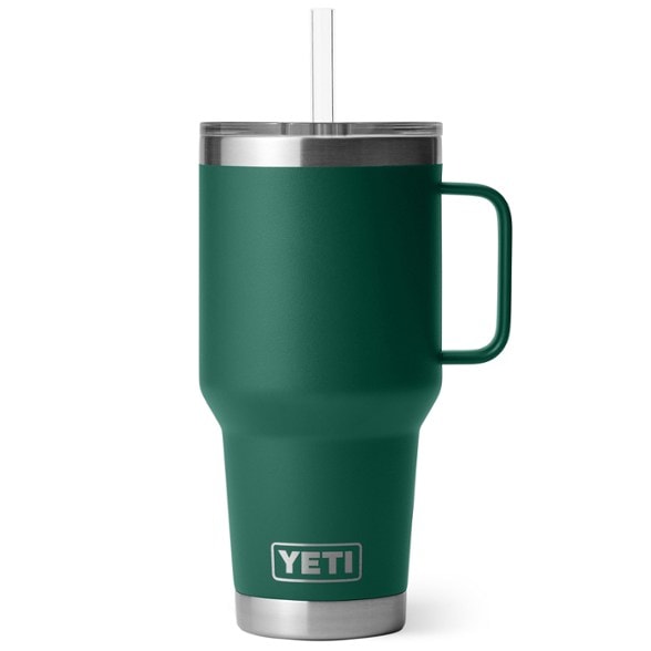 YETI Rambler 35 oz straw mug in outdoor setting filled with ice-cold beverage.