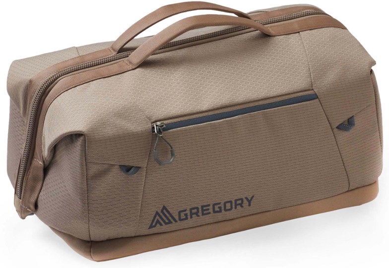 Gregory Alpaca 25L wide-mouth duffel bag open on grass, showcasing its wide opening and interior pockets
