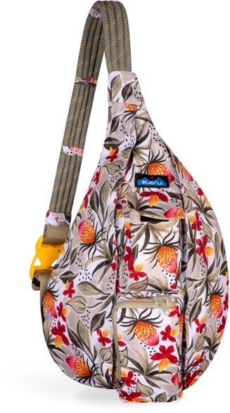 KAVU rope sling bag worn crossbody during hiking, showcasing adjustable strap and pockets