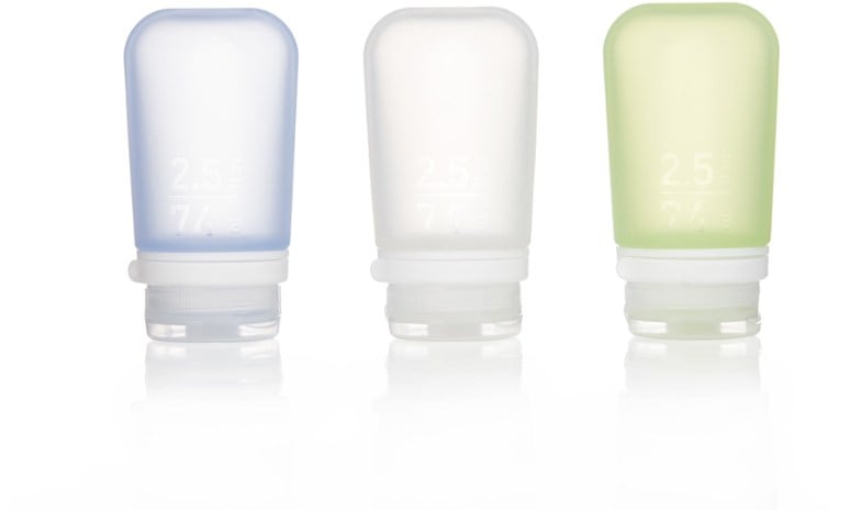 TravelMate squeeze bottles displayed on a picnic table, ideal for outdoor use.