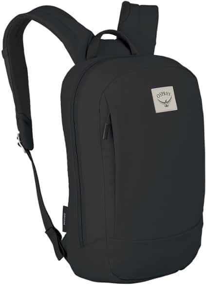 Front view of the Osprey Arcane Small daypack in a modern setting, showcasing its sleek design and recycled fabric texture.