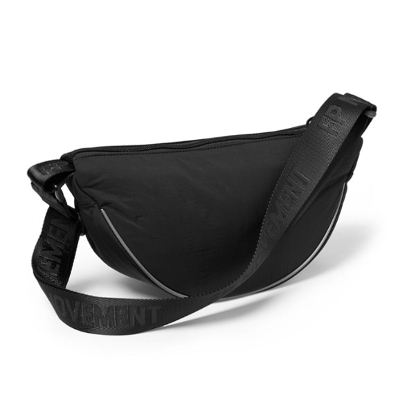 FP Movement Bullseye Sling Bag worn crossbody, showcasing reflective trim