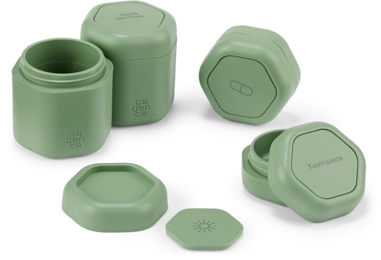 Close-up of leakproof travel capsules with labels for toiletries and pills