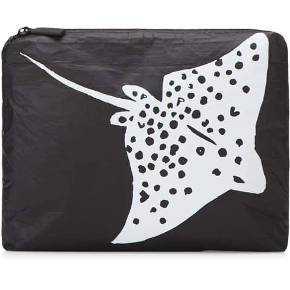 ALOHA Beach Clutch displayed on a sandy beach, showcasing its waterproof design.