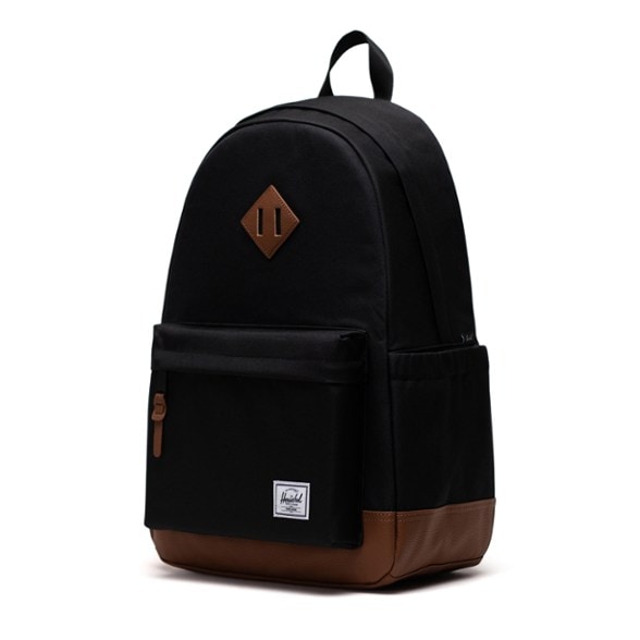 Heritage Eco Backpack in a natural outdoor setting showcasing the water bottle pocket and padded laptop sleeve.