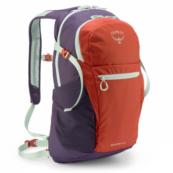 Osprey Daylite Plus pack worn by hiker on mountain trail, showing side pockets and harness system