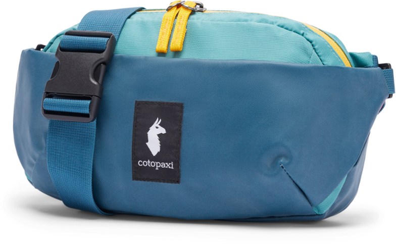 Cotopaxi Coso 2L hip pack worn crossbody during hiking, showcasing adjustable straps and compact design