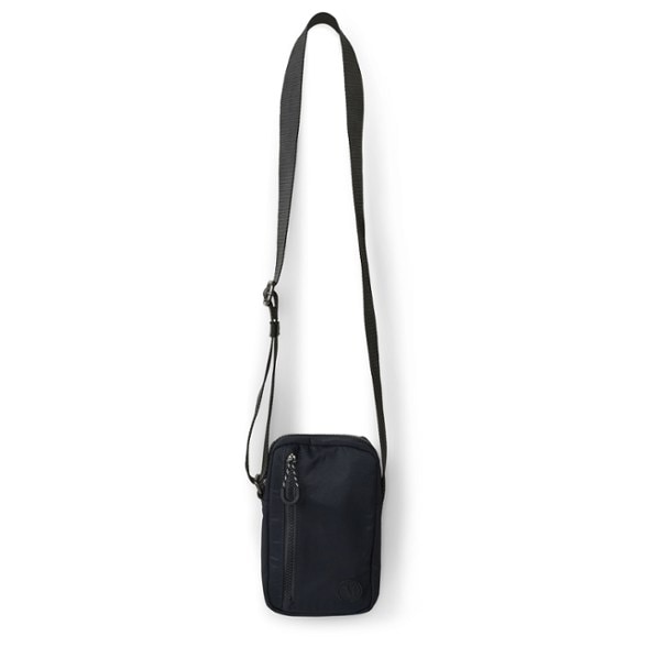 Front view of Vuori Traveler Mini Sling worn over shoulder, ideal for urban travel.