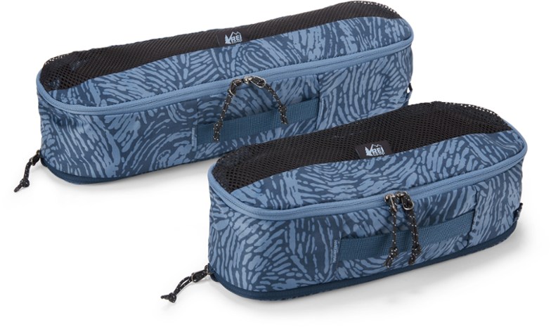 Voyageur expandable compression packing cubes laid open in a suitcase, showing how easily they fit and organize clothes.