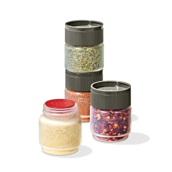 Close-up of TrailSpice portable spice shaker set filled with herbs and stacked neatly on a camp table