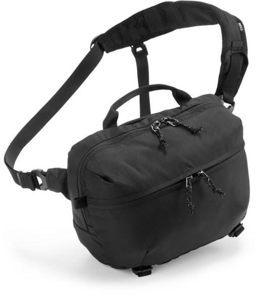REI Co-op Trailblazer 7L sling pack in a natural outdoor setting, highlighting its compact size and practical design for travel.