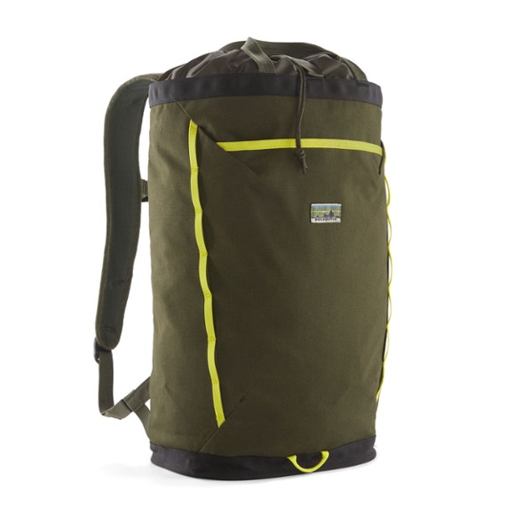 Patagonia Fieldsmith Linked Pack in classic black, shown front view on a wooden bench, highlighting its minimalist design and grab handles for an everyday carry.