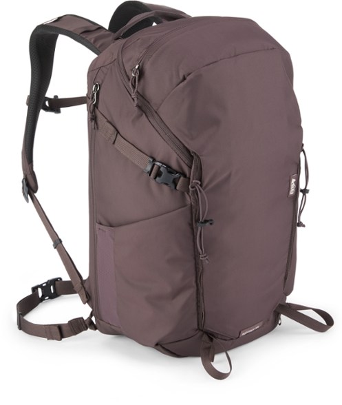 RuckPack 30L hiking backpack on a rocky trail, showing side pockets and compression straps