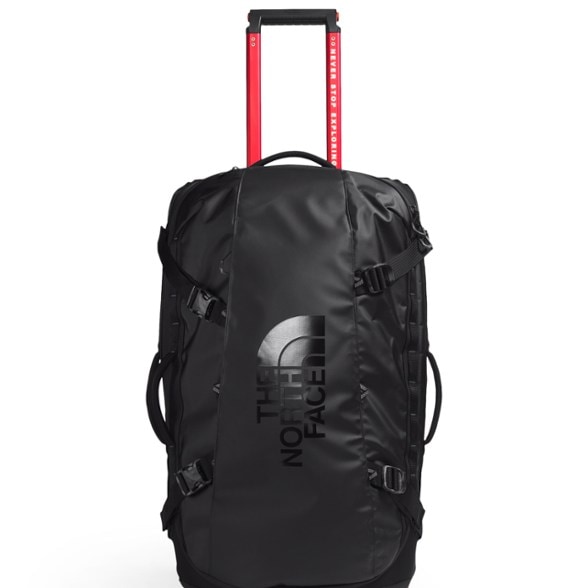 North Face rolling suitcase with external pockets and reflective details