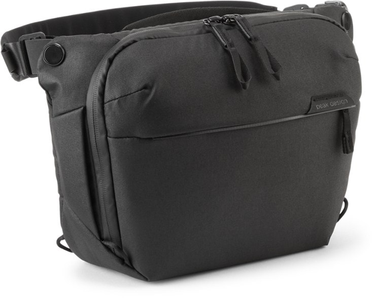 A close-up of the waterproof camera sling bag for DSLR in Coyote X-Pac fabric showing its recycled nylon shell and magnetic closure system.