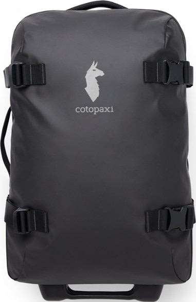 Cotopaxi Allpa 38L roller bag with wheels on cobblestone street