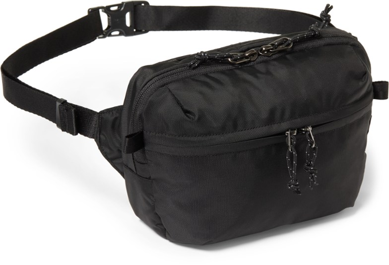 AdventurePro Waterproof Travel Waist Pack in use on a scenic hiking trail