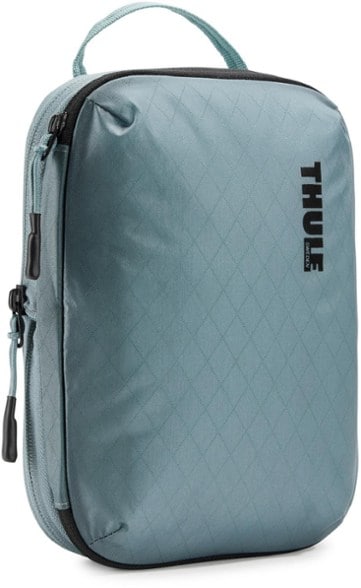 Close-up of the Thule AeroZip Travel Cube packed with rolled clothes, showing its compact compression.