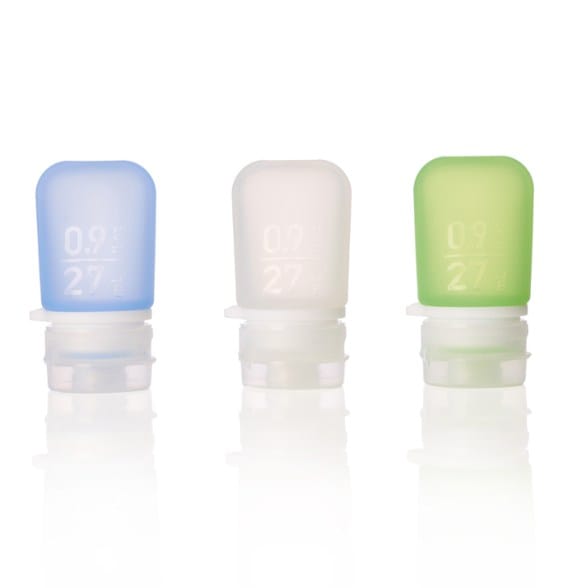 Close-up of reusable silicone squeeze bottles showing tapered design and leak-proof cap