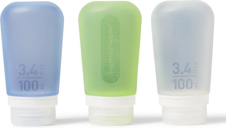 Three Humangear GoToob+ silicone squeeze bottles in assorted colors standing upright