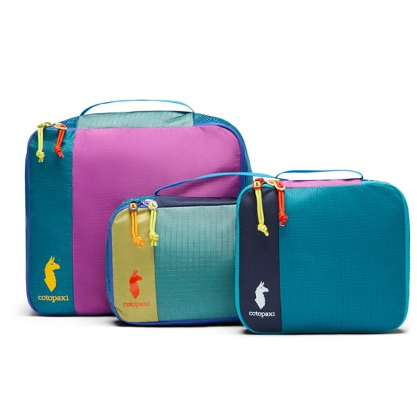 Cubos Del Dia packing cubes in a backpack, showcasing vibrant colors and organized compartments.