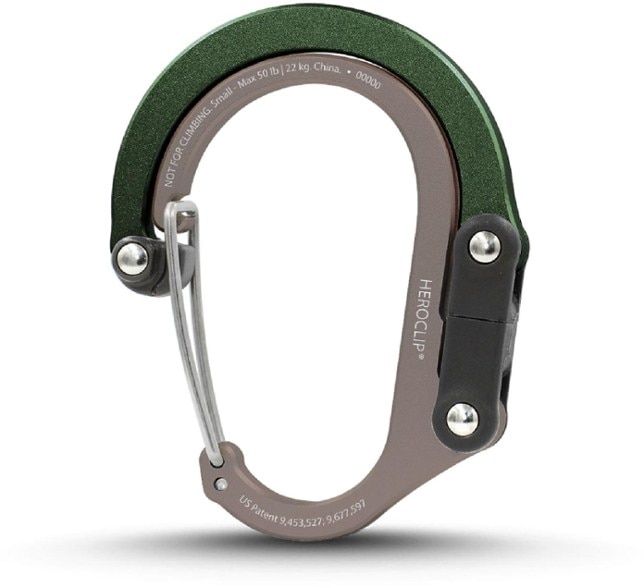 Small carabiner with 360-degree rotating hook hanging from a backpack in outdoor setting