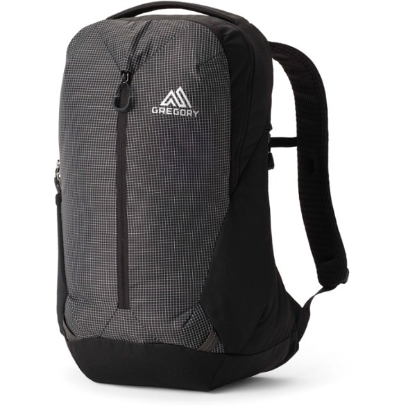 EcoTech Traveler 20L backpack in a park, highlighting its recycled design and utility features.