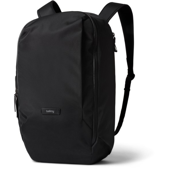 Front view of a sleek black commuter backpack standing upright, showcasing its clean lines and accessible front pocket, perfect for daily use.