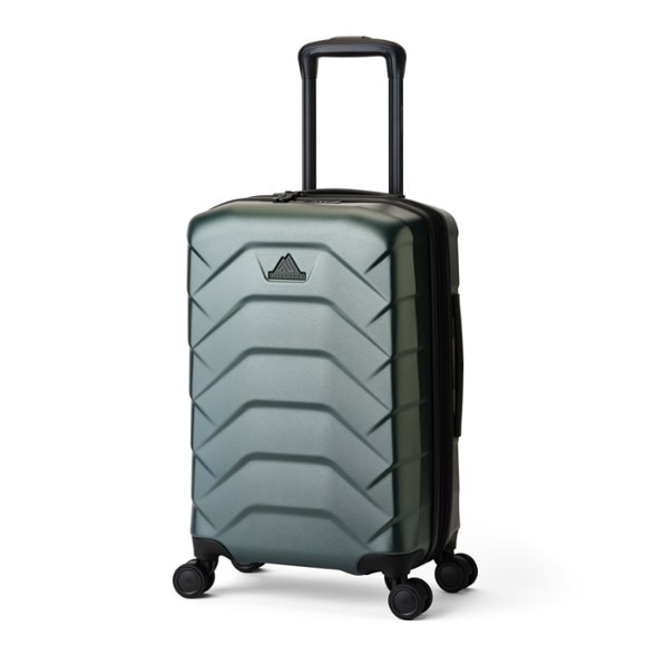 Gregory Cache 22 spinner luggage, shown from a front-side angle, highlighting its sleek black polycarbonate shell and dual spinner wheels.