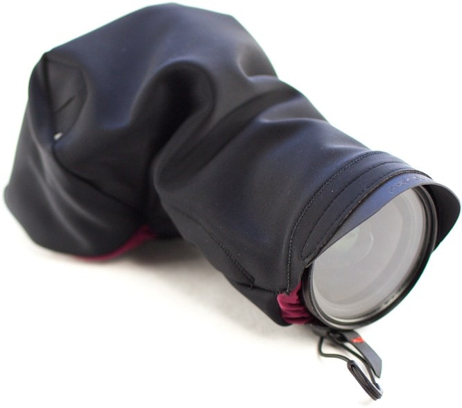 Weatherproof camera case protecting DSLR with tripod access in outdoor environment