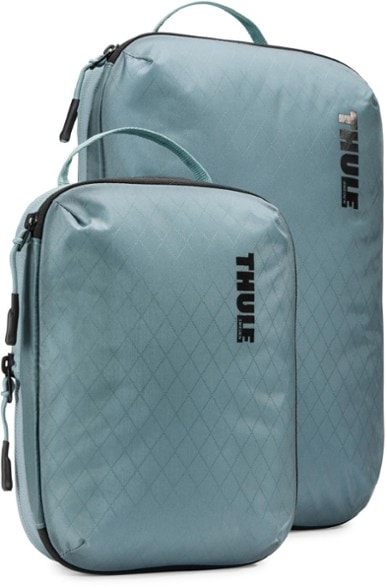 Overhead shot of Thule compression cubes in open suitcase showing organized packing