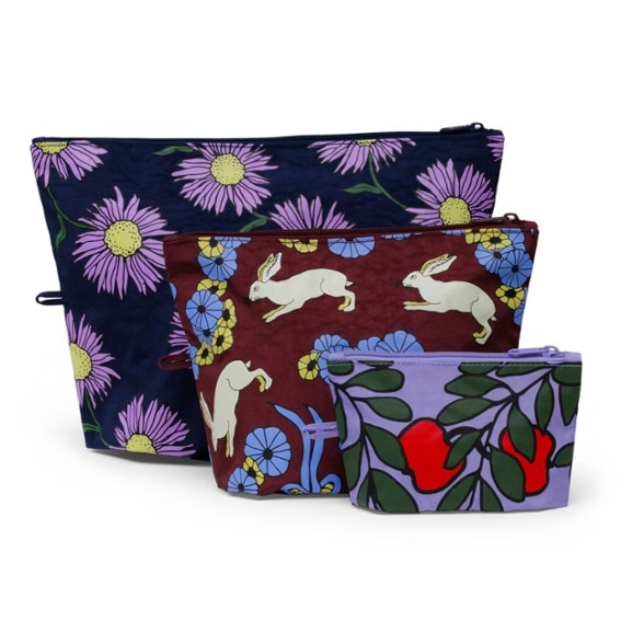 Go Travel Pouch Set displayed open on a suitcase, showing three sizes of waterproof organizer bags