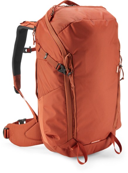 Men’s travel backpack with rain cover on a city street, showcasing its sleek profile and weather-resistant fabric.